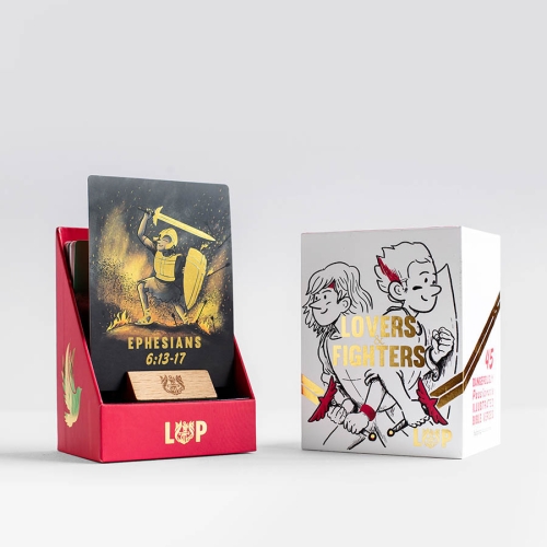 Front of the LOVERS&FIGHTERS gift box, from the left side, containing a collection of 45 Illustrated Verse Verse Cards and a little wooden stand, that make great gifts .